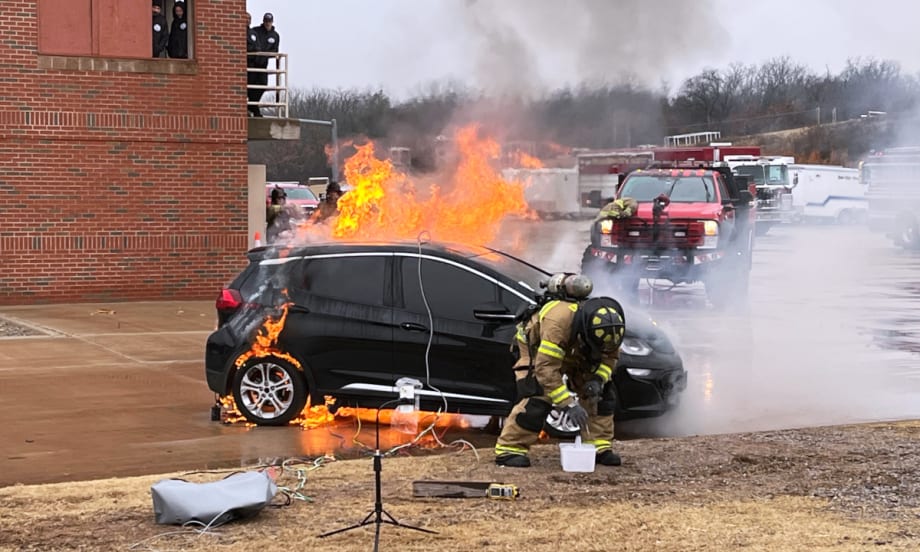 Firefighter fighting an EV car fire.