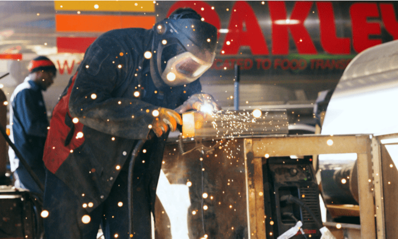 Worker is shown welding in a maintenance job in transportation industry.