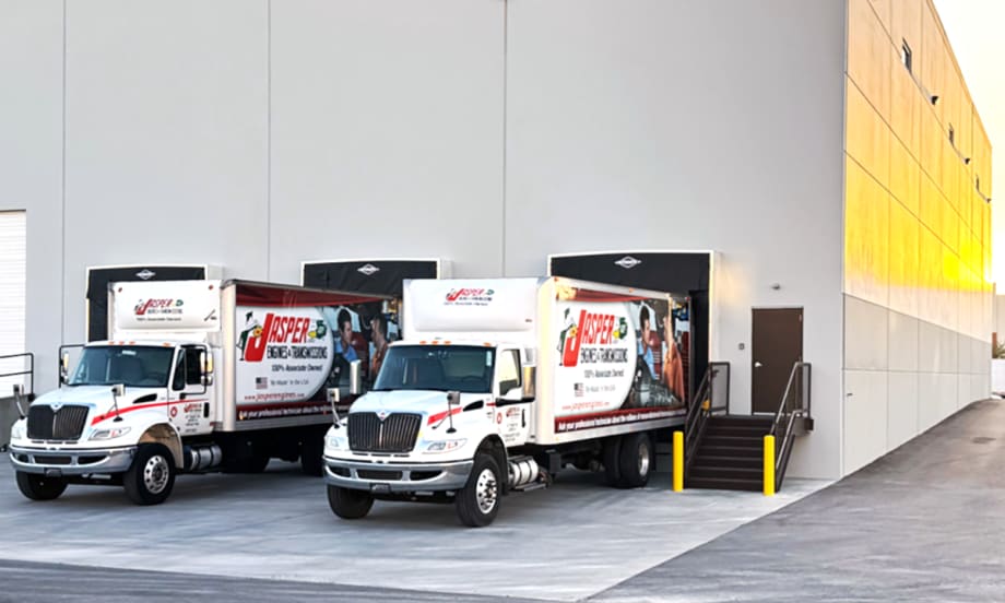 Photo of two trucks backed up to the dock at a distribution center.
