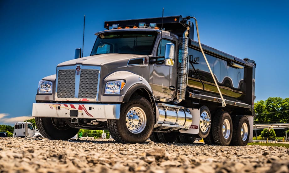dump truck against a blue sky and parked on rocky ground