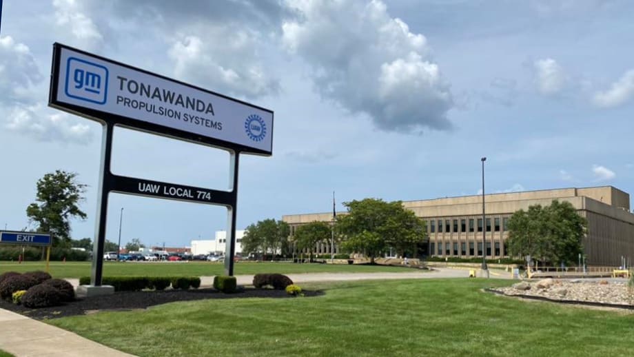 Front view of the GM Tonawanda Propulsion Systems plant in Buffalo, New York, showing the main sign with UAW Local 774 and the facility in the background on a partly cloudy day.