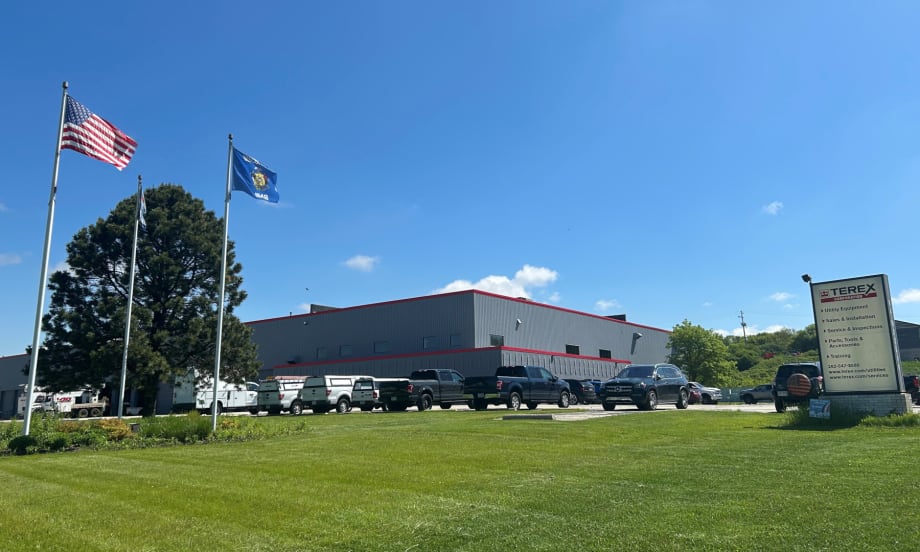 External photo of an industrial building against a blue sky.