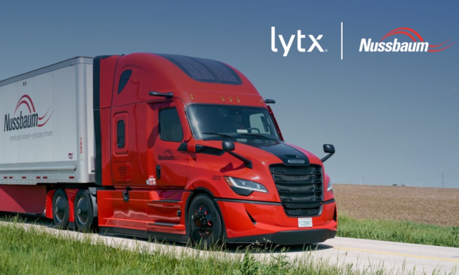 Red tractor trailer driving on a road, inset company logos for Lytx and Nussbaum.