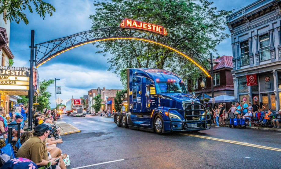 Truck in a parade at dusk.