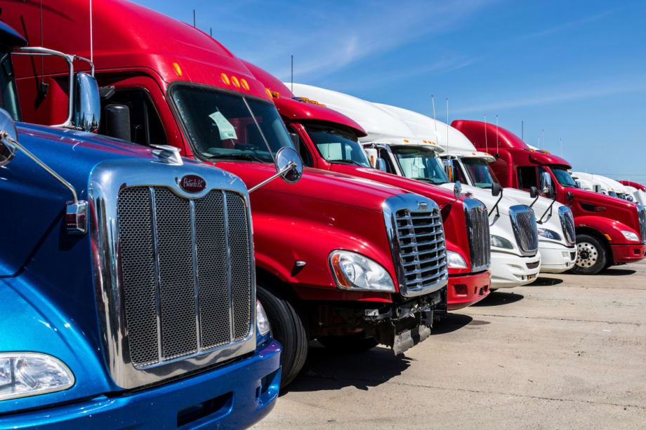 Lineup of blue, red, and white used trucks