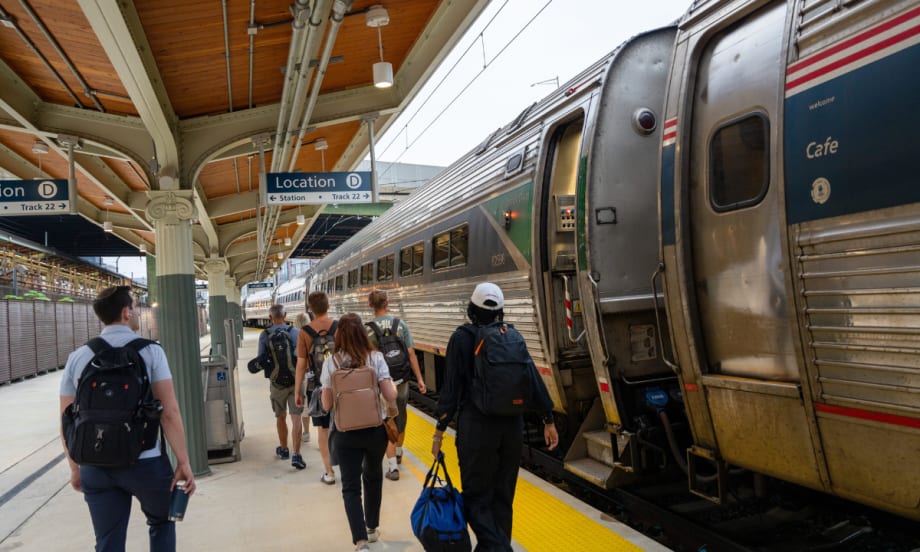Passengers board an Amtrak train at Washington Union Station’s new Track 22 platform under a covered structure with clear signage and updated accessibility features.