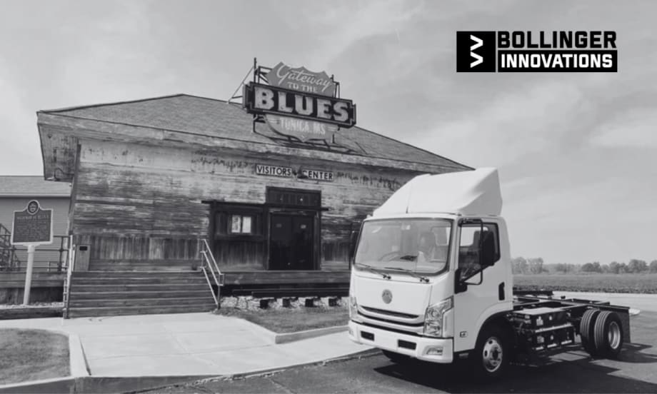 Bollinger Innovations electric cab chassis truck parked outside the Gateway to the Blues Visitors Center in Tunica, Mississippi, with the historic sign and building in the background.