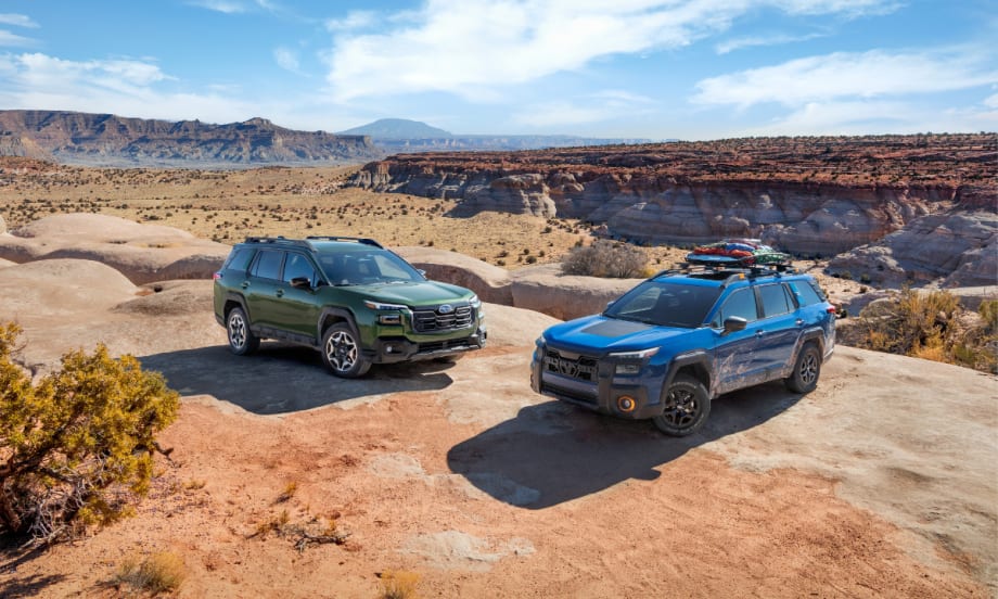 Two 2026 Subaru Outback SUVs parked on desert terrain, showcasing redesigned styling and adventure-ready utility.