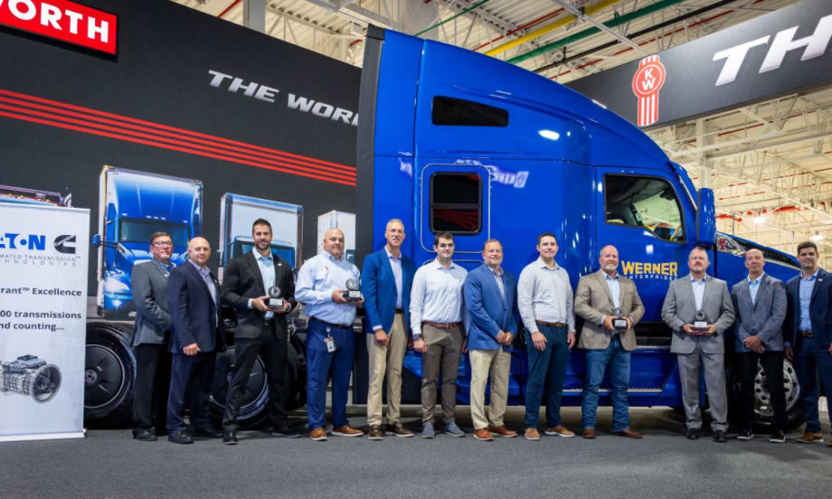Group of Eaton Cummins and Werner Enterprises representatives standing in front of a blue Kenworth T680, commemorating the 500,000th Endurant transmission milestone.