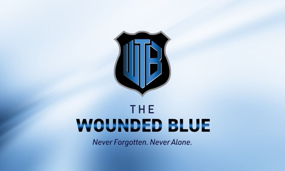 The Wounded Blue logo: shield emblem with WB letters in blue and black