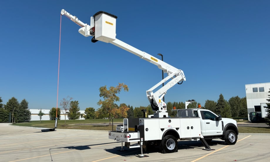 A utility bucket truck extended against a blue sky.