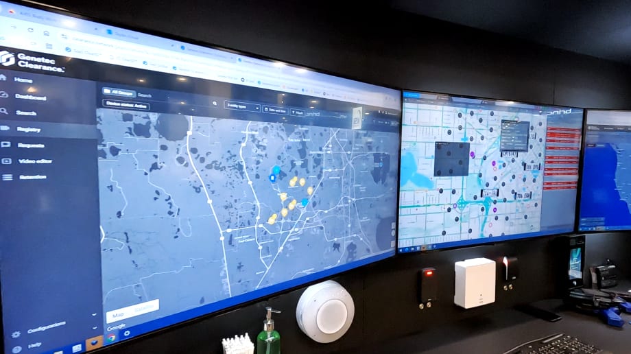 Photo of three computer screens displaying software soluitions in a trade show booth.