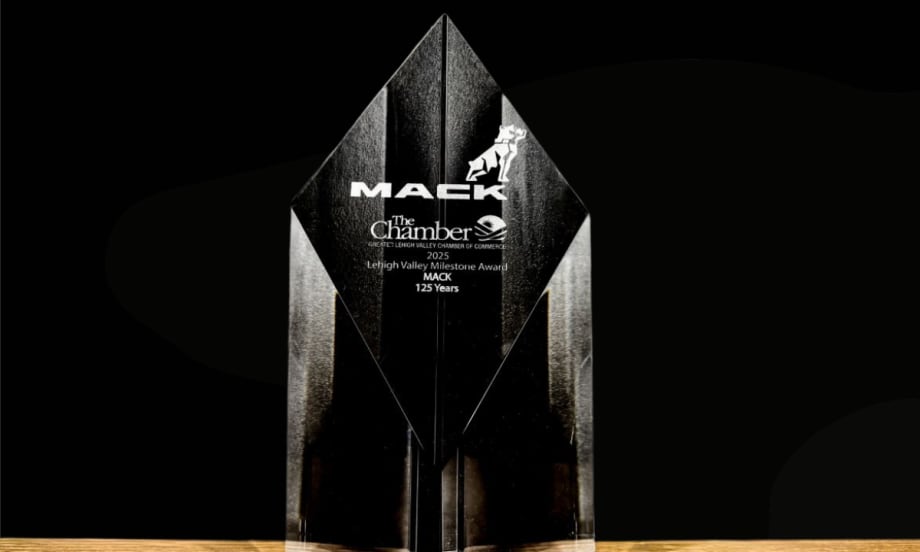 A clear crystal award engraved with “Mack” and “Lehigh Valley Milestone Award 2025 – Mack 125 Years,” displayed against a black background.