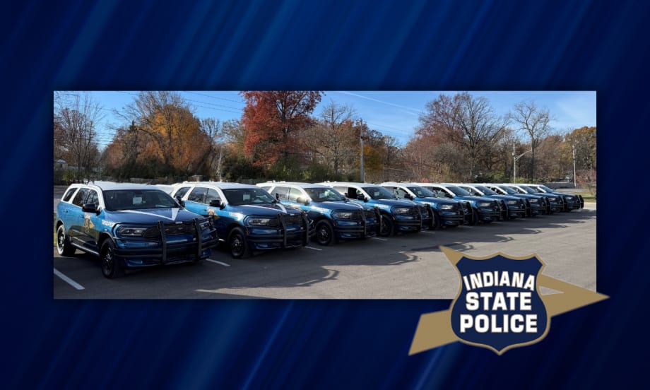 Row of newly designed Indiana State Police Dodge Durango patrol vehicles parked outdoors, marking the rollout of the new fleet design for graduating troopers.