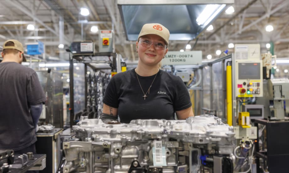Toyota manufacturing employee assembling hybrid powertrain components on the factory floor as part of the company’s expanded U.S. hybrid production investment.