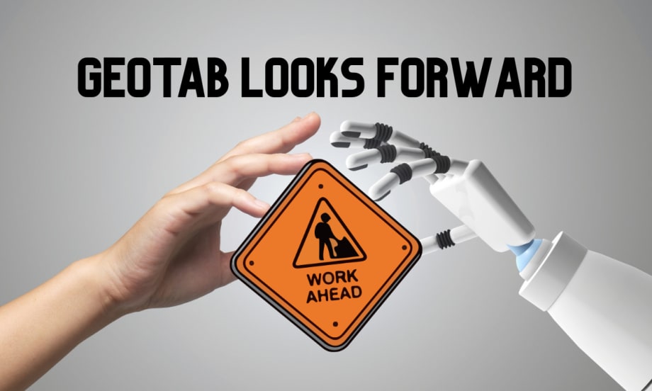 Human and robot hands hold a road sign reading Work Ahead, representing Geotab’s 2026 fleet predictions focused on AI, autonomy, and data quality.