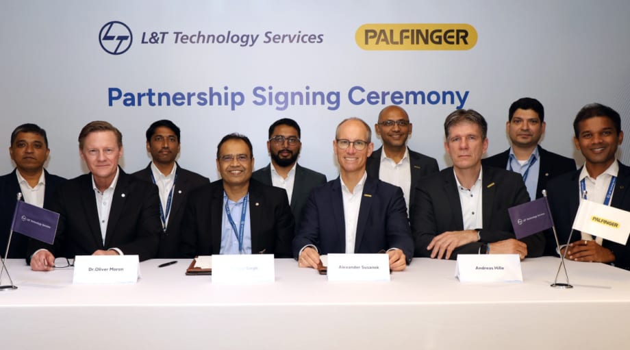 Group of men in business attire seated at a table to sign agreements.
