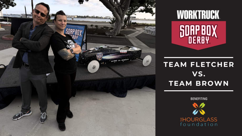 Lauren Fletcher and Chris Brown stand beside a soap box derby car ahead of the 2026 Corporate Soap Box Derby Challenge, where Team Fletcher will race to support skilled trades scholarships.