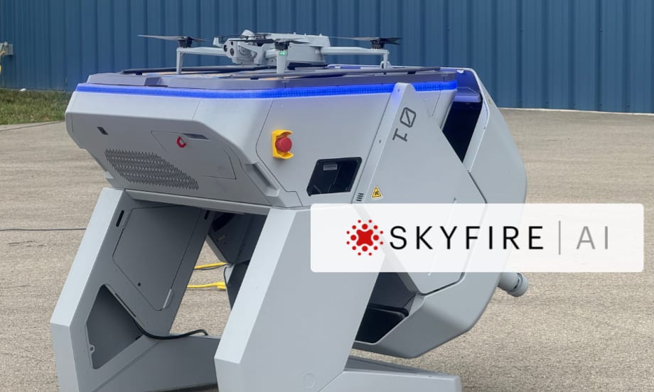Drone-in-a-box docking station with a quadcopter on top, branded SkyfireAI, positioned outdoors on a concrete surface.