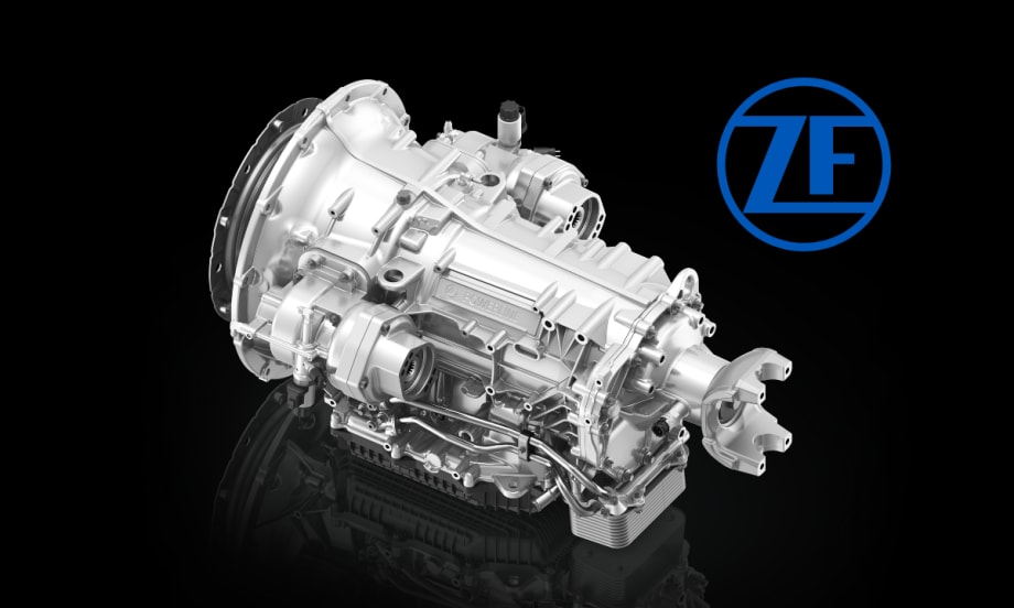Silver truck transmission against a black background and a blue ZF logo.