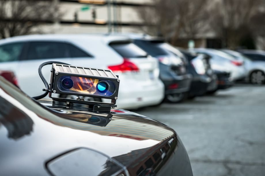 An automated license plate reader mounted on rear trunk of a car.