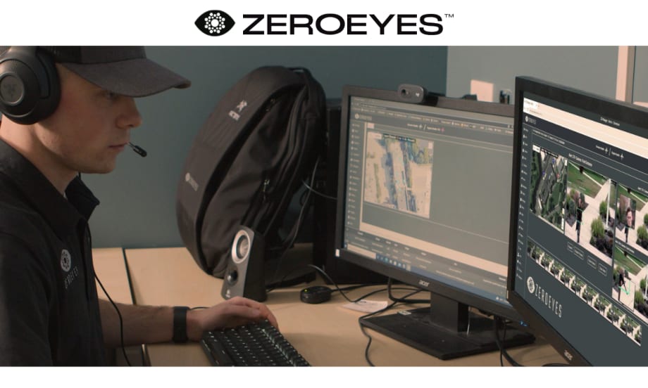 Security worker watching computer monitors, with a white area at top with a logo for ZeroEyes.