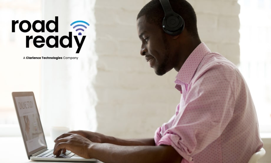 side view of a man working on a laptop computer with upper left logo for Road Ready.