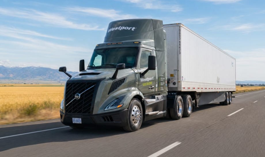 Gray Volvo tractor pulling trailer on open highway