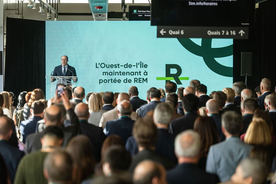 A man stands at a podium in front of a large crowd.