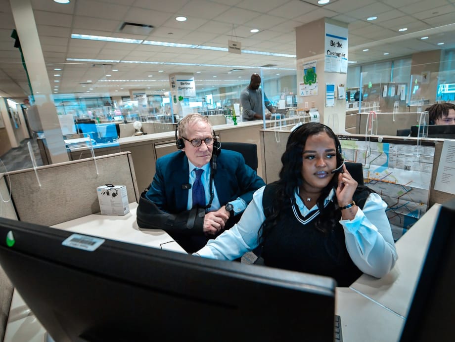 MTA Chair & CEO Janno Lieber sits with a customer service employee and takes calls.