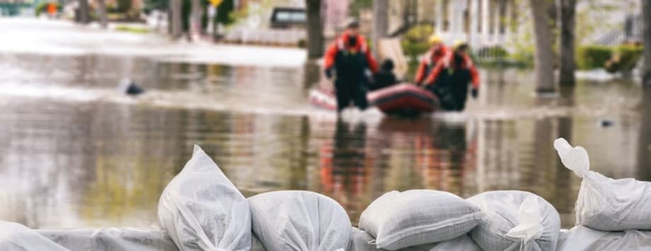 Rescuers dragging a boat duing a flood