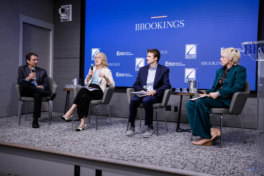 A panel of four people sitting on a stage.