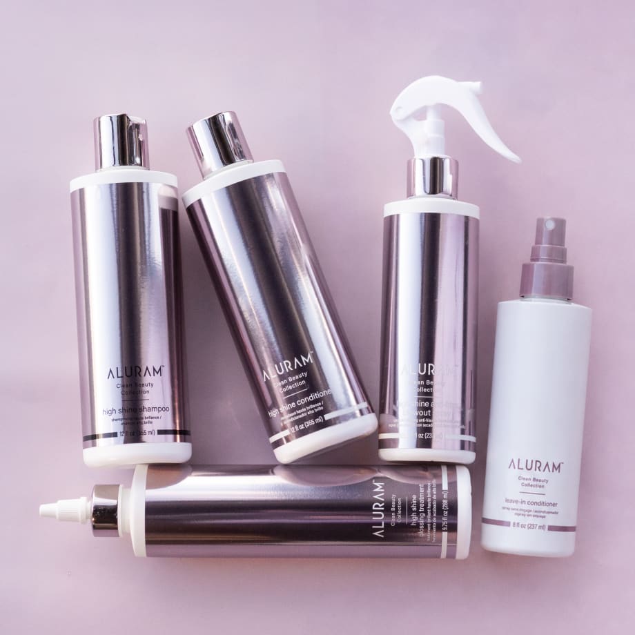 a collection of hair products in shiny pink bottles