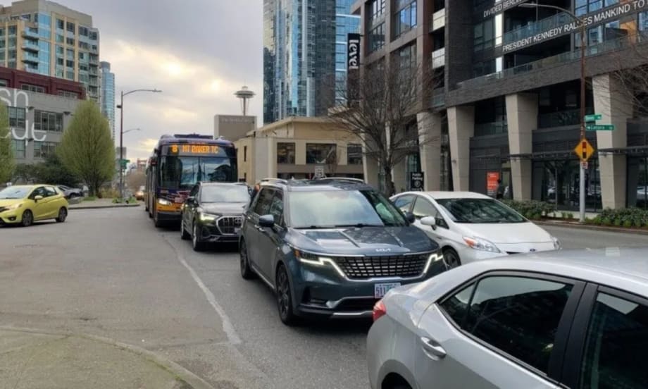 A Route 8 bus travels on Denny Way in congested traffic.