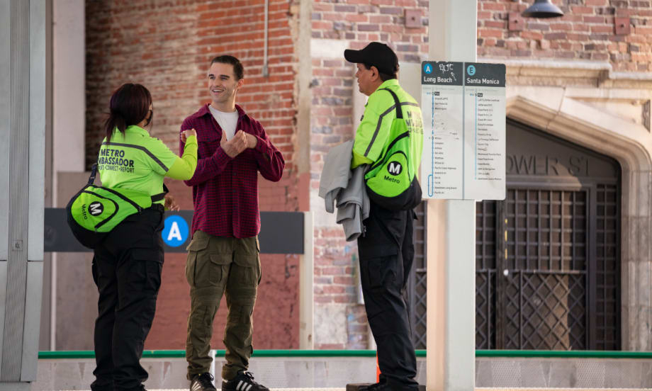 A man speaks with two Los Angeles Metro Ambassadors.