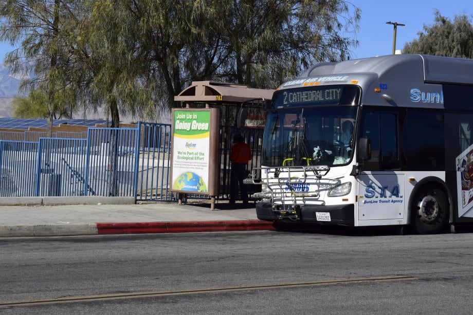 A SunLine clean air bus at a stop.