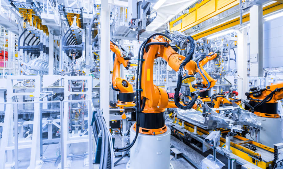 inside of automotive manufacturing plant, robotic assembly