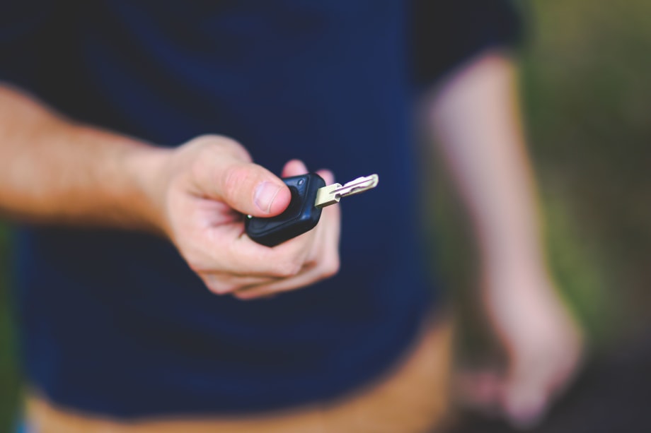 Photo of man holding a car key