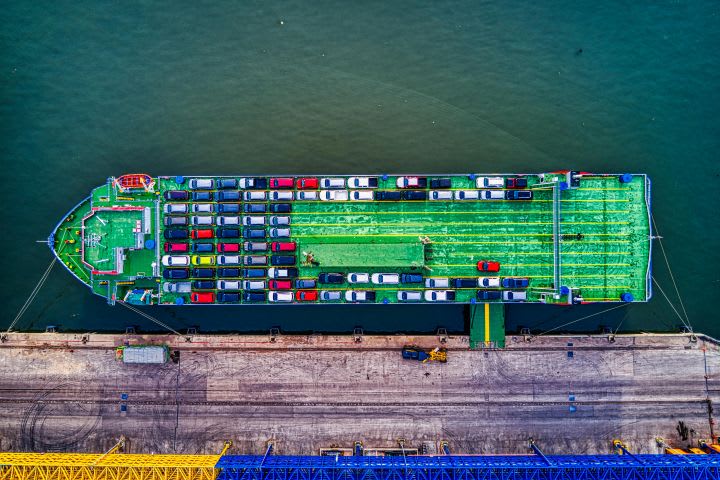 Overhead view of container cargo ship loaded with vehicles