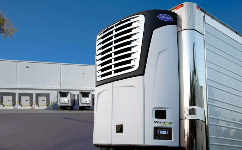 Carrier Transicold electric transport refrigeration unit on stationary trailer with loading docks in the background