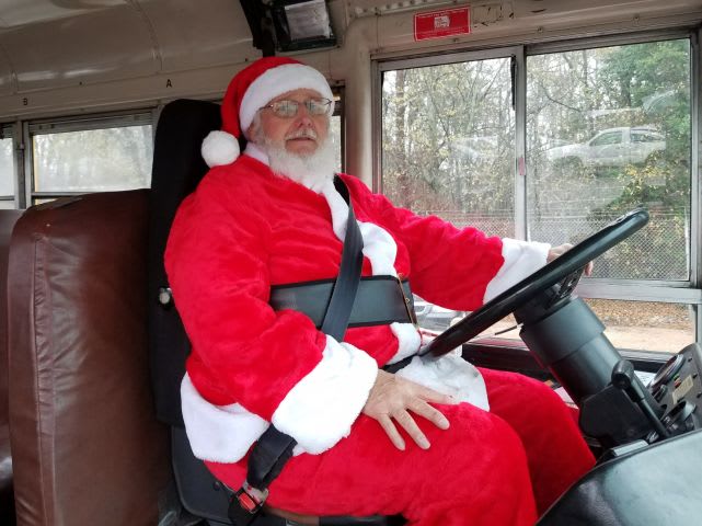 Santa Spreads Christmas Cheer at the Wheel of a School Bus