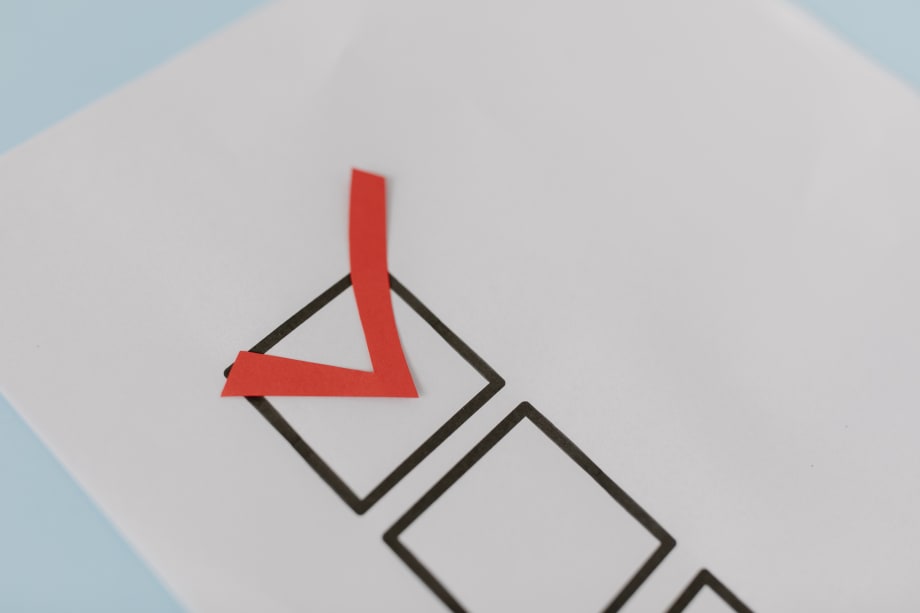 A checkbox on a sheet of paper checked in red