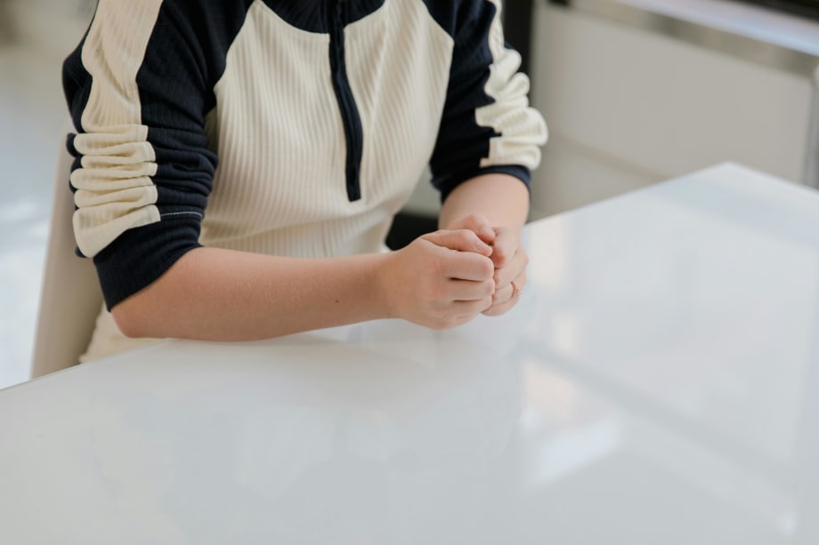 Woman in casual clothing sitting at a desk