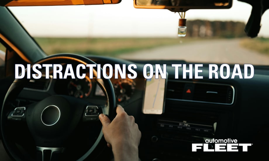 A person with hands on the steering wheel driving