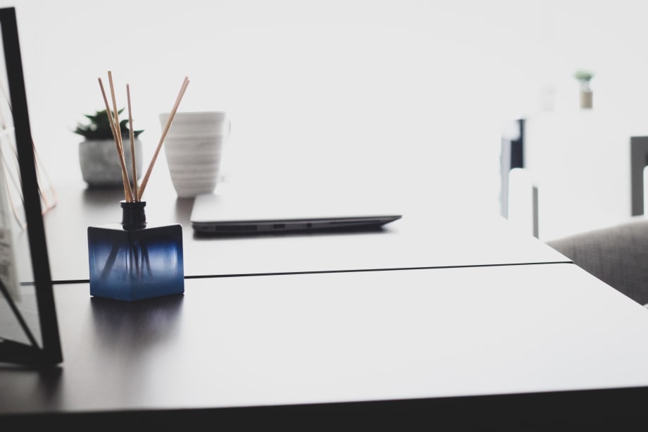 Photo of essential oil diffuser on desk next to laptop