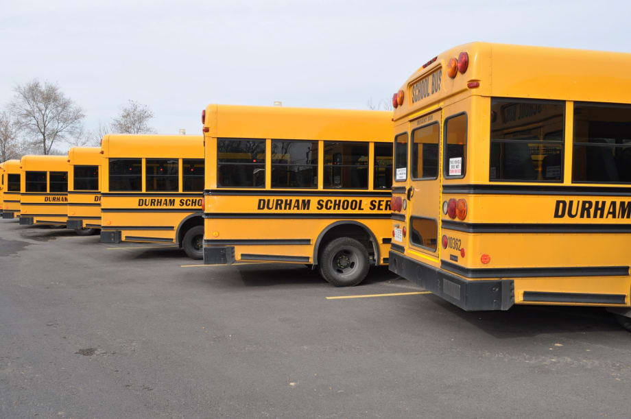 Lineup of the back end of Durham School Service school buses.