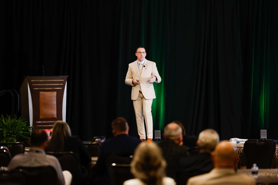Dustin Gingerich standing on stage giving a presentation