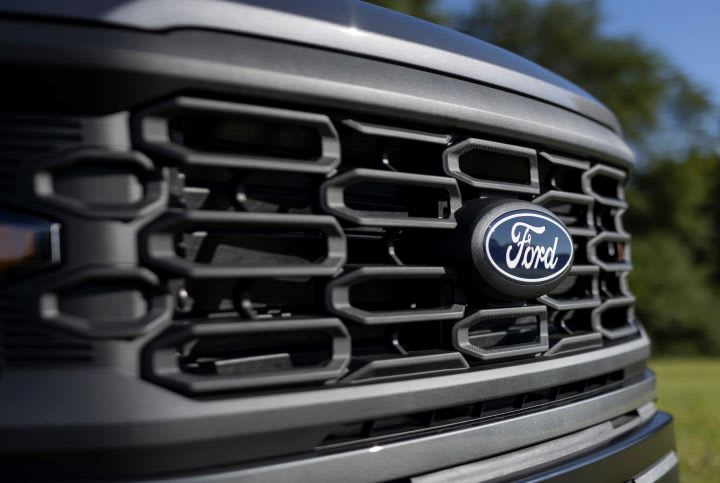 front grill of a Ford truck with blue Ford emblem