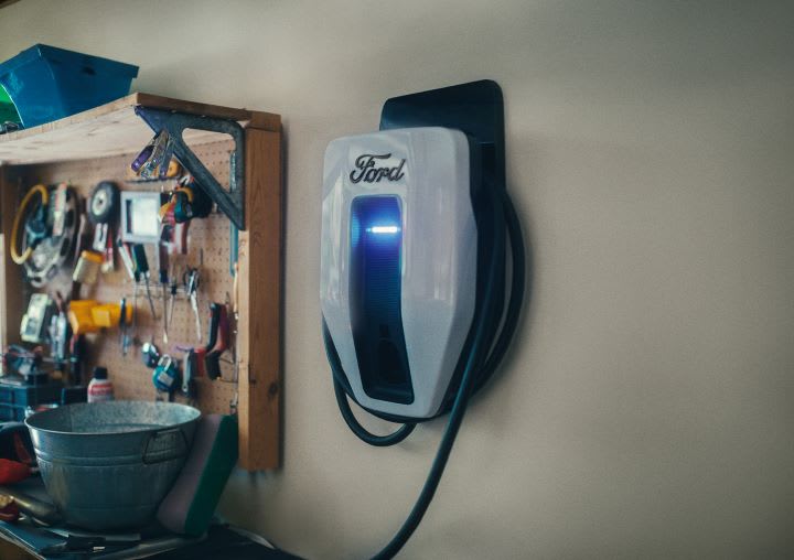 Photo of wall-mounted Ford electric-vehicle charger in a home