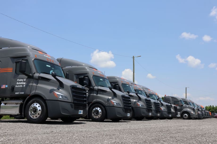 Line of gray semi trucks with Fraley & Schilling logo
